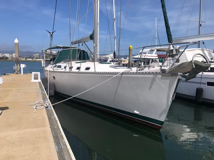 Snug Harbor Yacht Photos Pics Sailboat Catalina 470, 2002 model, docked at marina under clear blue sky.