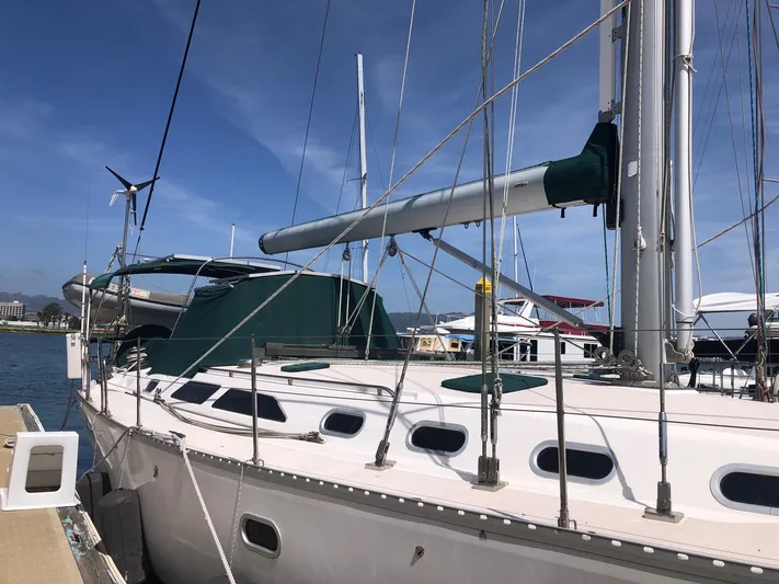 Snug Harbor Yacht Photos Pics Sailboat Catalina 470, 2002 model, docked at marina under clear blue sky.