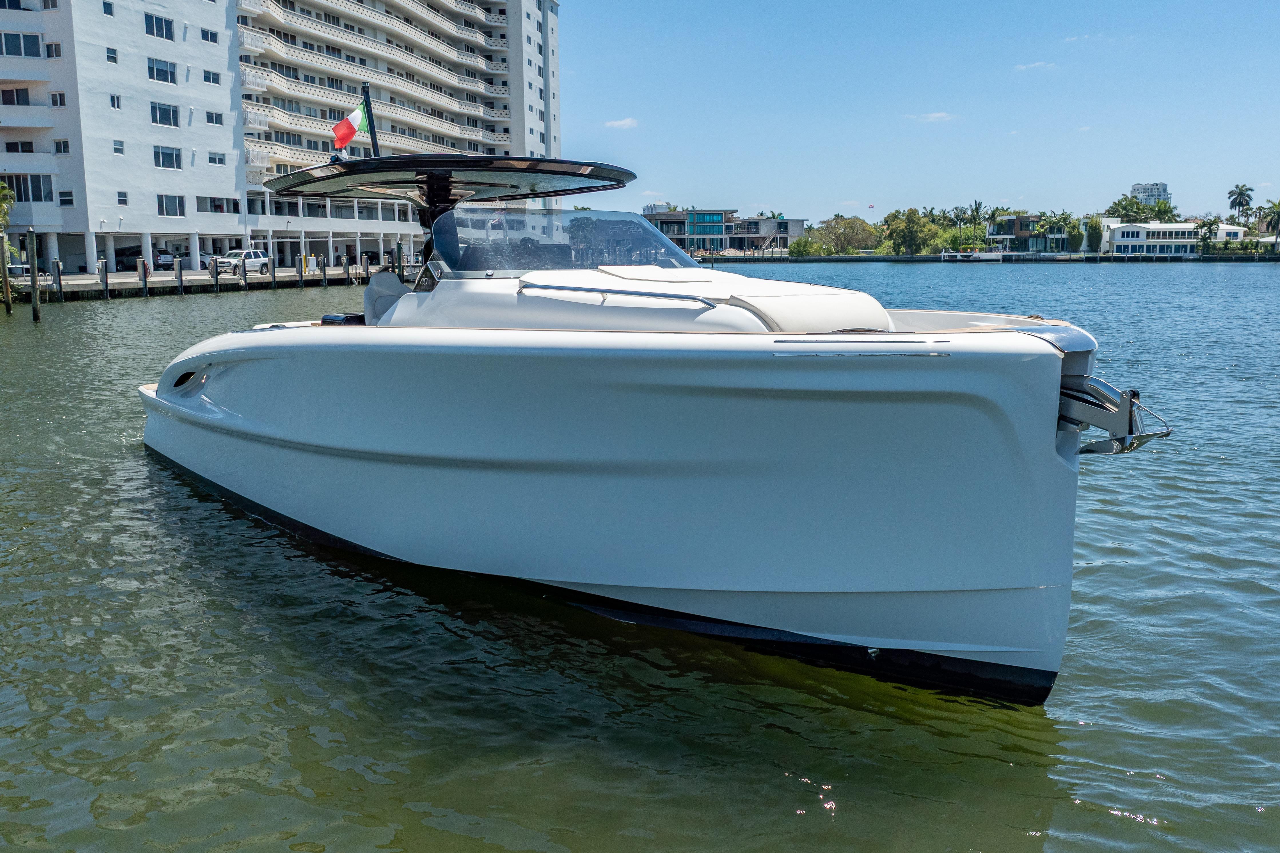 2027 Solaris Power 40 Open yacht docked near waterfront buildings.