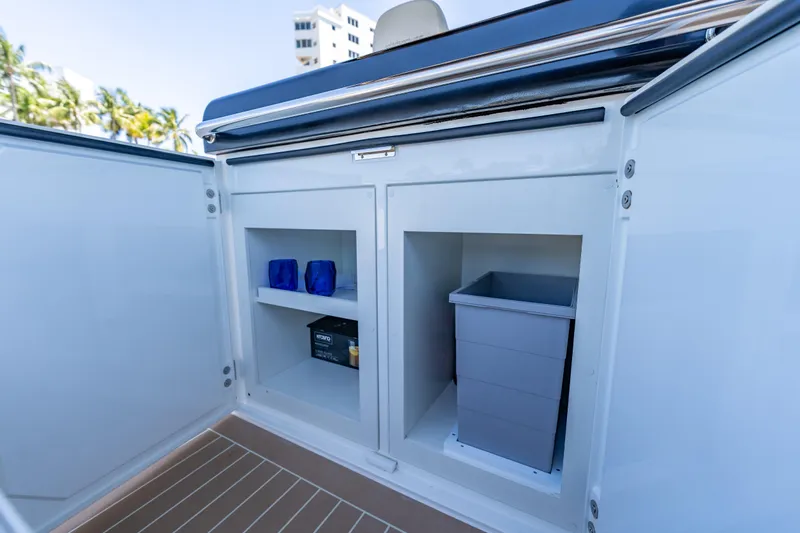  Yacht Photos Pics Open storage compartment on Solaris Power 40 Open yacht, featuring shelves and a waste bin.