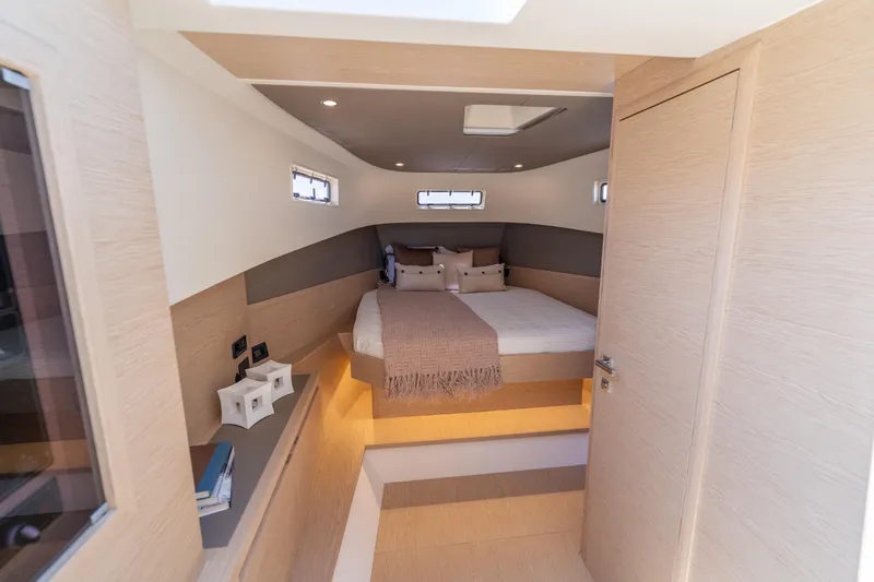  Yacht Photos Pics Luxurious cabin interior of 2027 Solaris Power 40 Open yacht, featuring modern design and cozy bedding.