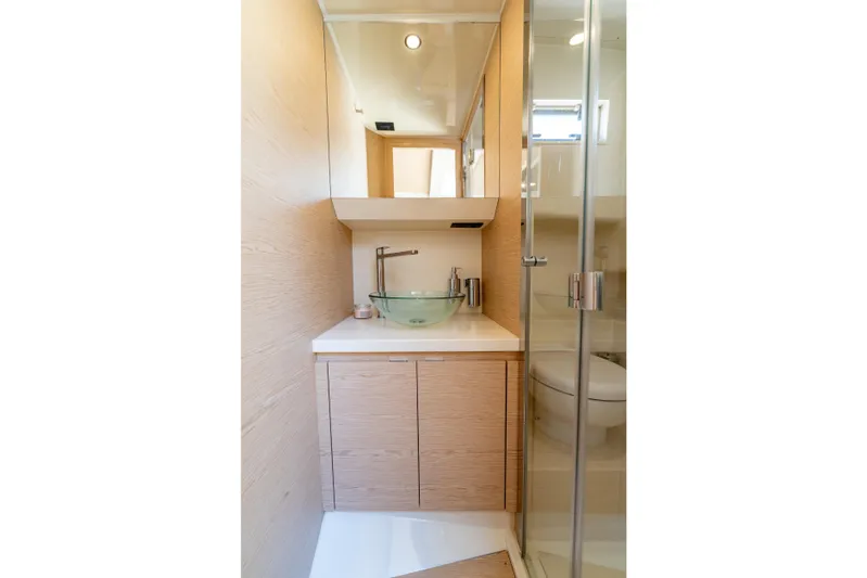  Yacht Photos Pics Modern bathroom in 2027 Solaris Power 40 Open yacht with glass sink and wooden cabinetry.