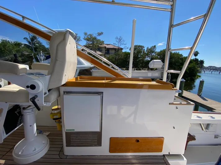 Red Castles Yacht Photos Pics 2000 Little Harbor 42 Whisper Jet helm station with seating and storage, docked by the water.