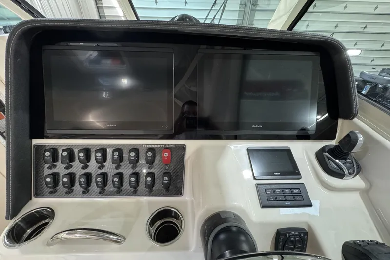 Freedom Yacht Photos Pics Control panel of 2026 Grady-White Freedom 325 boat with Garmin displays and switches.