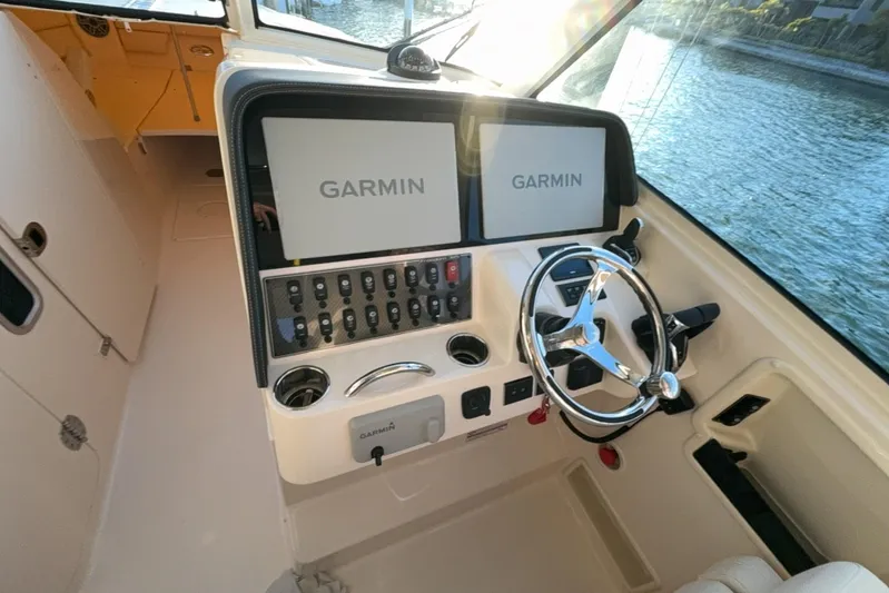 Freedom Yacht Photos Pics 2026 Grady-White Freedom 325 helm with dual Garmin displays and steering wheel.
