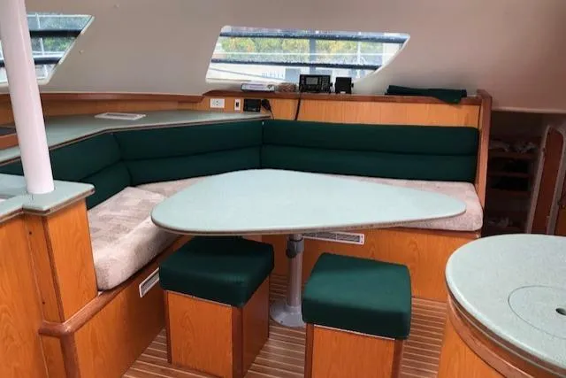 S/v Vr Yacht Photos Pics Interior of 2005 Manta 42 MK II yacht with green cushioned seating and wooden accents.
