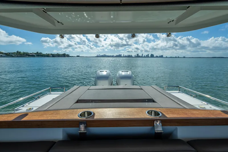  Yacht Photos Pics View from Axopar 37 XC Cross Cabin, 2017, overlooking serene ocean and distant city skyline.