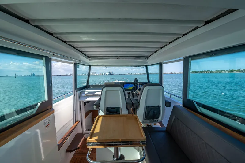  Yacht Photos Pics Interior view of 2017 Axopar 37 XC Cross Cabin, overlooking serene waters.