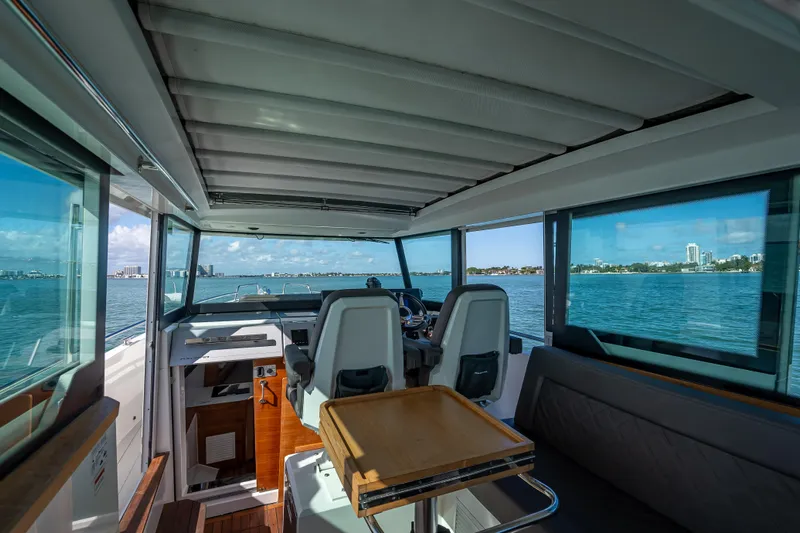  Yacht Photos Pics Interior of 2017 Axopar 37 XC Cross Cabin with ocean view and seating area.