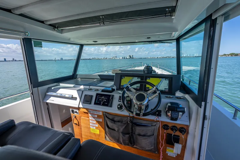  Yacht Photos Pics Interior view of 2017 Axopar 37 XC Cross Cabin boat cockpit with navigation equipment.