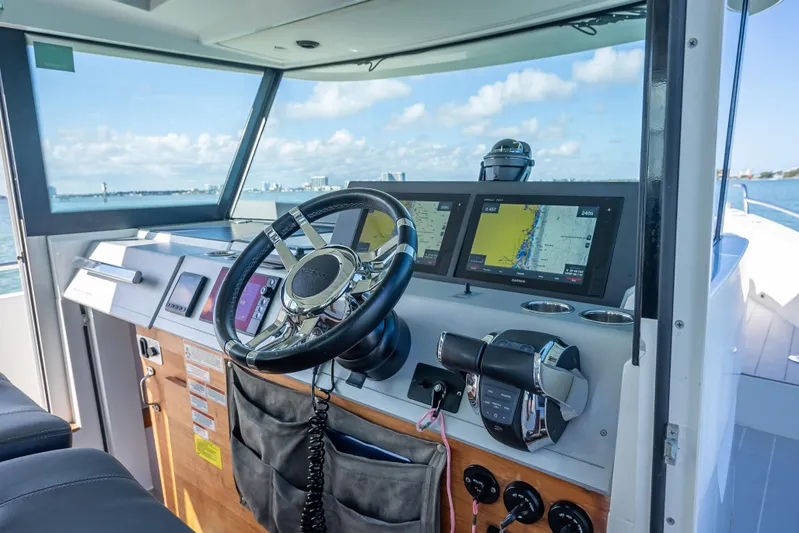  Yacht Photos Pics Interior view of 2017 Axopar 37 XC Cross Cabin boat cockpit with navigation screens.