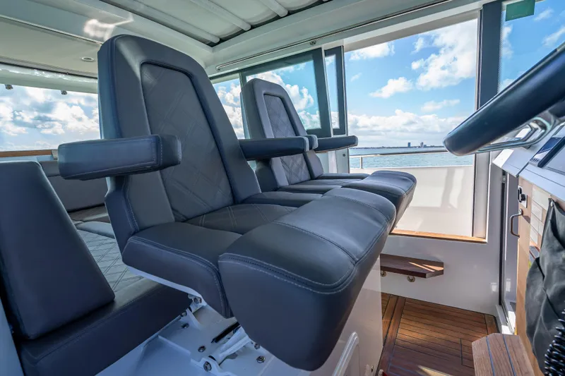  Yacht Photos Pics Luxurious interior of 2017 Axopar 37 XC Cross Cabin with leather seating and ocean view.