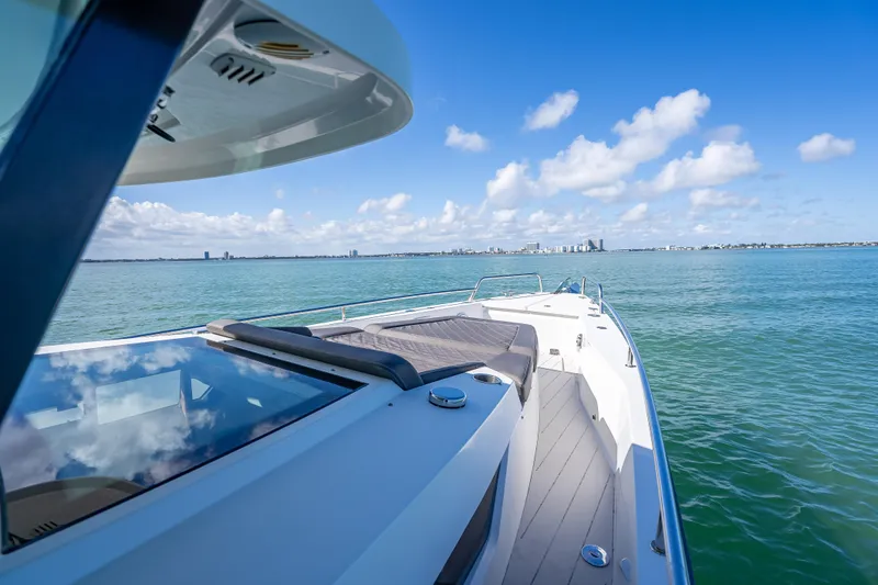  Yacht Photos Pics 2017 Axopar 37 XC Cross Cabin cruising on a sunny day, clear blue waters.