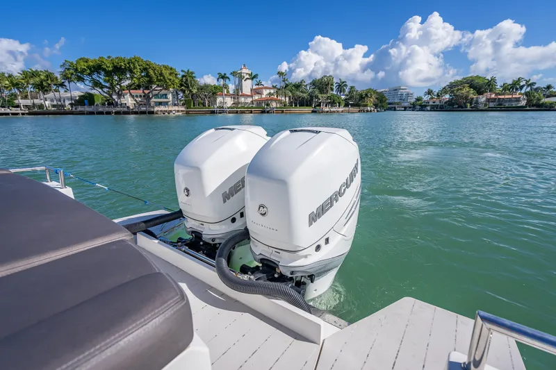  Yacht Photos Pics 2017 Axopar 37 XC Cross Cabin with twin Mercury outboard engines on a scenic waterway.