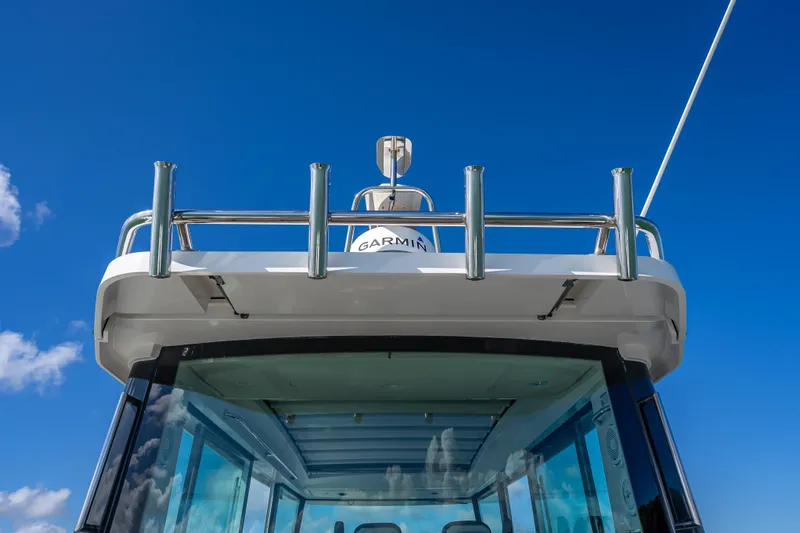  Yacht Photos Pics Axopar 37 XC Cross Cabin 2017 boat with Garmin equipment against blue sky.