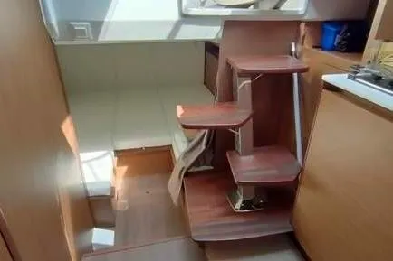  Yacht Photos Pics 2019 Jeanneau Cap Camarat 10.5 WA interior with wooden steps and seating area.