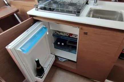  Yacht Photos Pics 2019 Jeanneau Cap Camarat 10.5 WA boat kitchen with fridge, sink, and stove.