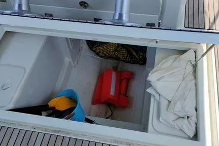  Yacht Photos Pics Storage compartment on a 2019 Jeanneau Cap Camarat 10.5 WA boat with various items.