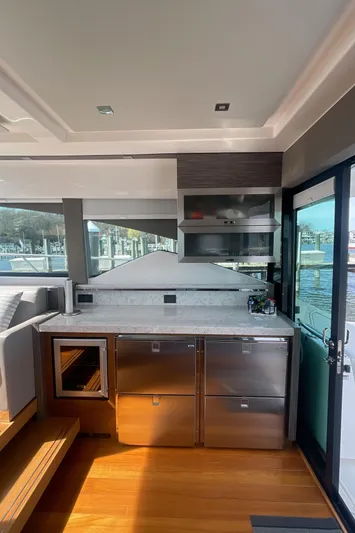  Yacht Photos Pics 2020 Tiara Yachts 53 Coupe interior kitchen with modern appliances and waterfront view.