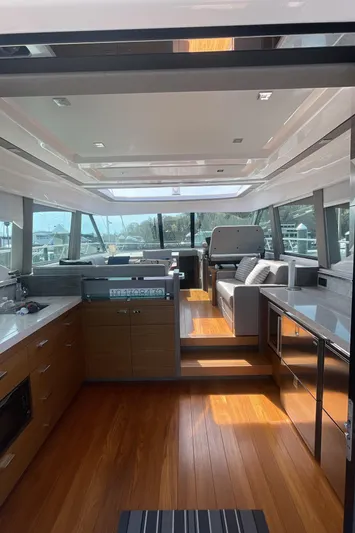  Yacht Photos Pics 2020 Tiara Yachts 53 Coupe interior with modern kitchen and seating area.