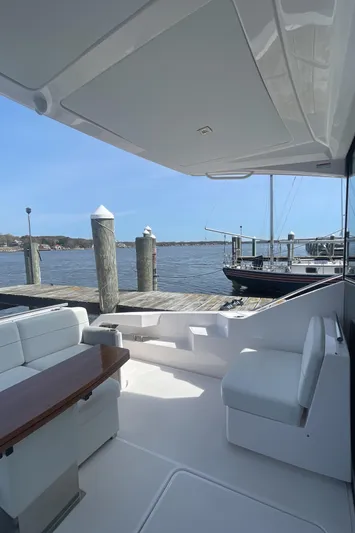  Yacht Photos Pics 2020 Tiara Yachts 53 Coupe, elegant deck view at marina with serene water backdrop.