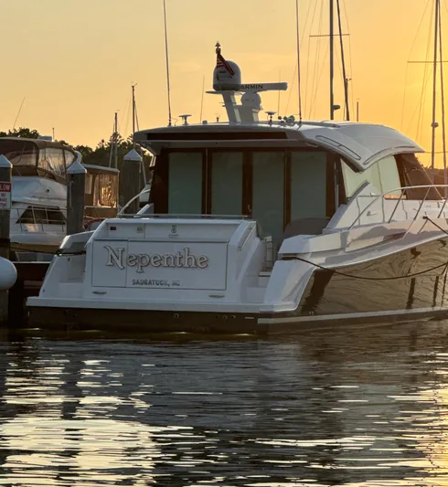  Yacht Photos Pics 2020 Tiara Yachts C53 Coupe docked at sunset, reflecting on calm water.