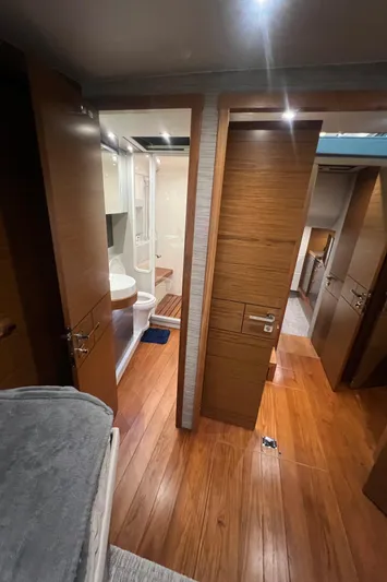  Yacht Photos Pics 2020 Tiara Yachts C53 Coupe interior with wooden flooring and modern bathroom.