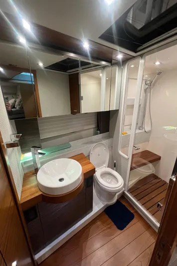  Yacht Photos Pics Luxurious bathroom in 2020 Tiara Yachts C53 Coupe with modern fixtures and wooden accents.