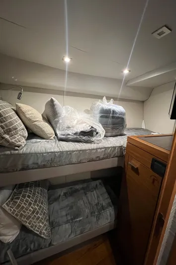  Yacht Photos Pics 2020 Tiara Yachts C53 Coupe cabin with bunk beds and cozy bedding.