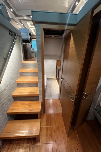  Yacht Photos Pics Interior of 2020 Tiara Yachts C53 Coupe, featuring wooden stairs and modern design.