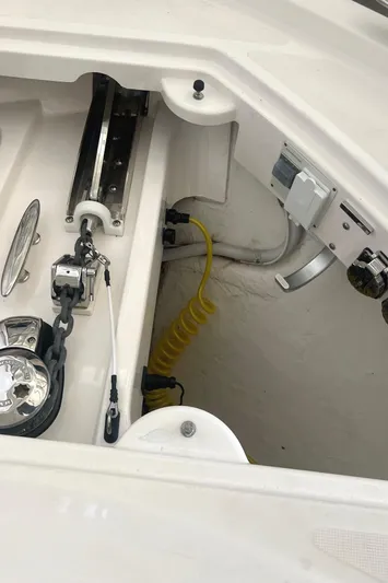  Yacht Photos Pics 2020 Tiara Yachts C53 Coupe anchor compartment with winch and coiled yellow hose.