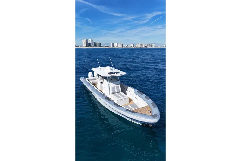  Yacht Photos Pics Ocean 1 370 boat, 2022 model, cruising on blue ocean with city skyline in background.
