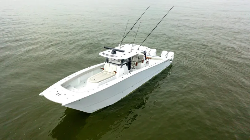  Yacht Photos Pics 2023 Freeman 42 LR boat on calm water, equipped with fishing rods.