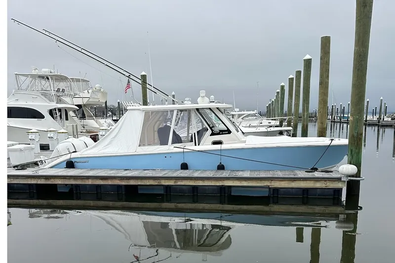  Yacht Photos Pics 2024 Pursuit S 328 Sport boat docked at marina, overcast sky.