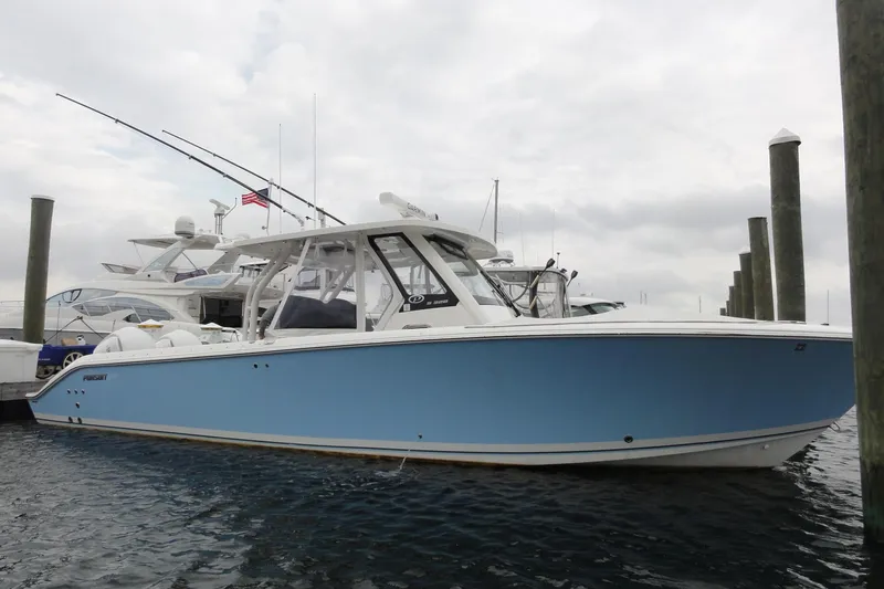  Yacht Photos Pics 2024 Pursuit S 328 Sport boat docked in marina, side view.