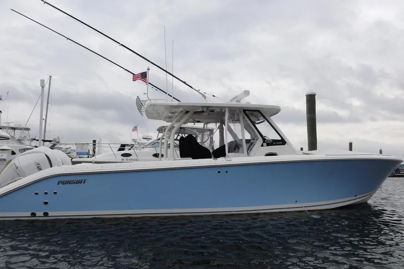  Yacht Photos Pics 2024 Pursuit S 328 Sport boat docked in marina, side view.