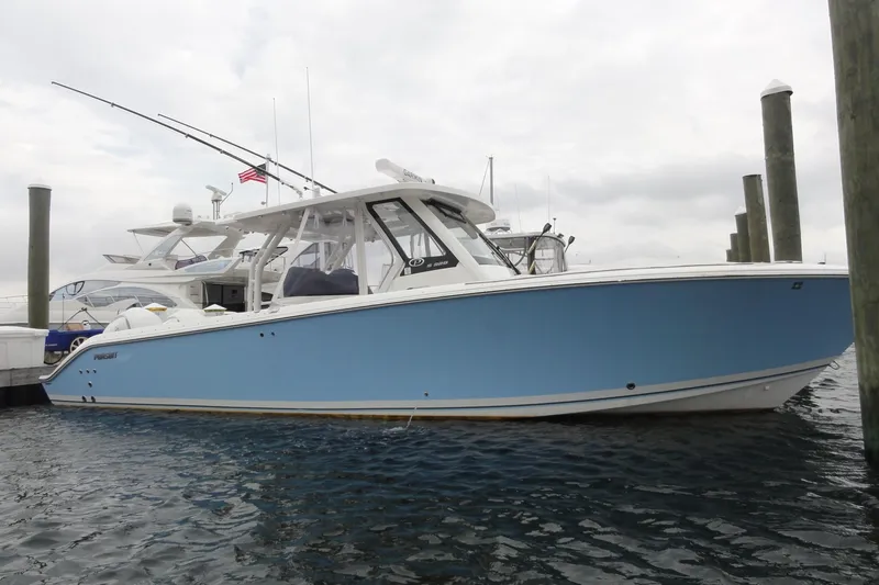  Yacht Photos Pics 2024 Pursuit S 328 Sport boat docked in marina, side view.