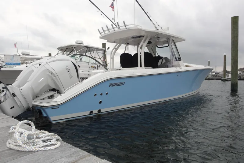  Yacht Photos Pics 2024 Pursuit S 328 Sport boat docked, featuring sleek design and Yamaha engines.