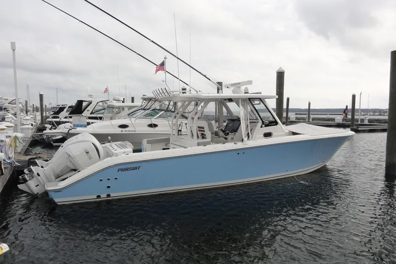  Yacht Photos Pics 2024 Pursuit S 328 Sport boat docked in marina, side view.