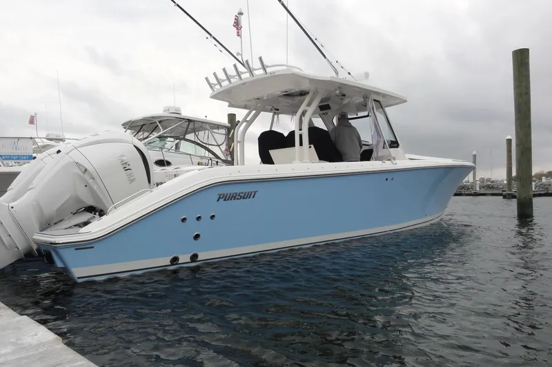  Yacht Photos Pics 2024 Pursuit S 328 Sport boat docked in marina, side view.
