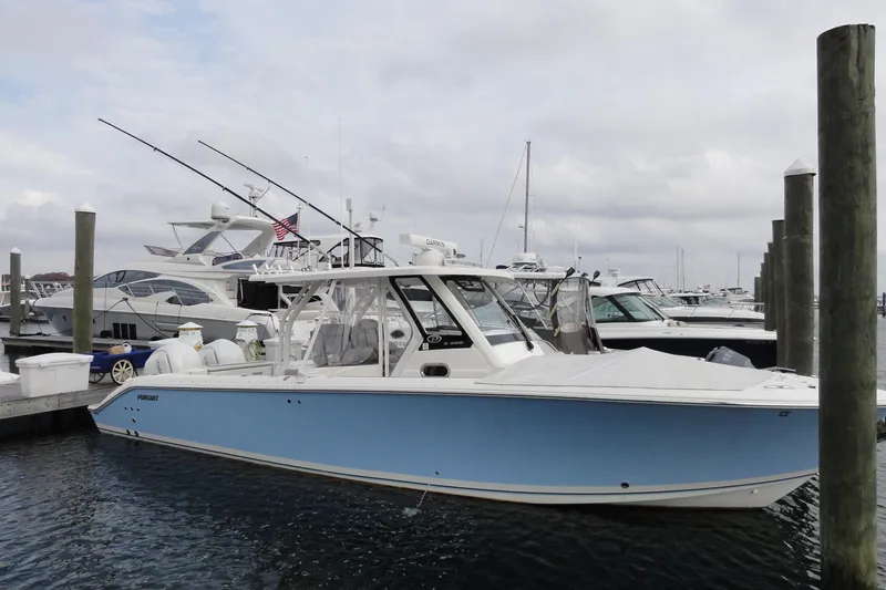  Yacht Photos Pics 2024 Pursuit S 328 Sport boat docked at marina, featuring sleek design and modern amenities.