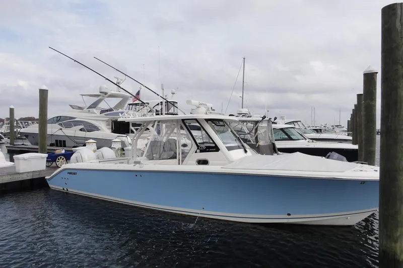  Yacht Photos Pics 2024 Pursuit S 328 Sport boat docked at marina, featuring sleek blue design.