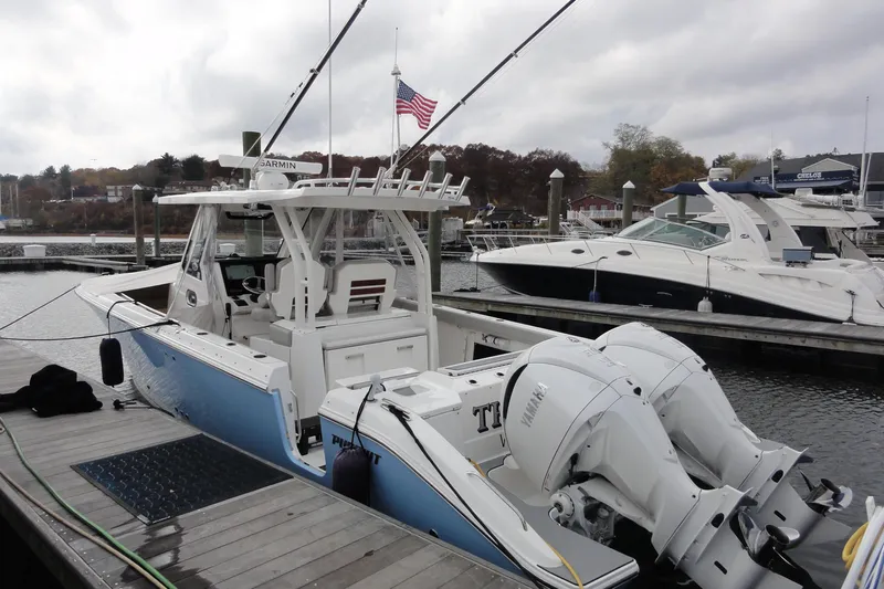  Yacht Photos Pics 2024 Pursuit S 328 Sport boat docked with twin Yamaha engines, American flag visible.