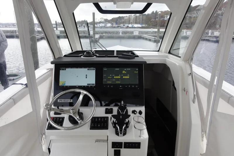  Yacht Photos Pics 2024 Pursuit S 328 Sport boat helm with modern navigation displays and steering wheel.
