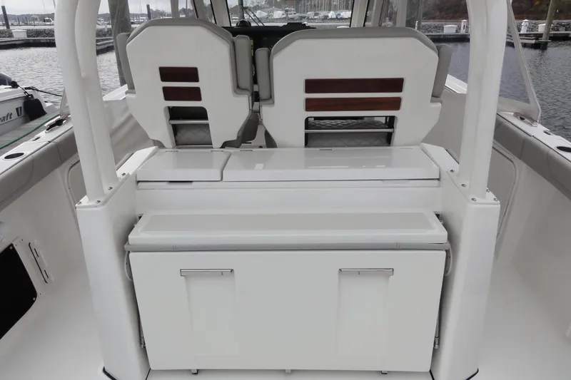  Yacht Photos Pics 2024 Pursuit S 328 Sport boat interior with dual seats and storage compartments.