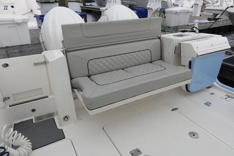  Yacht Photos Pics 2024 Pursuit S 328 Sport boat with luxurious gray seating and sleek design at the dock.