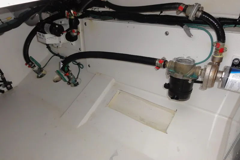  Yacht Photos Pics 2024 Pursuit S 328 Sport boat interior plumbing system with hoses and valves.