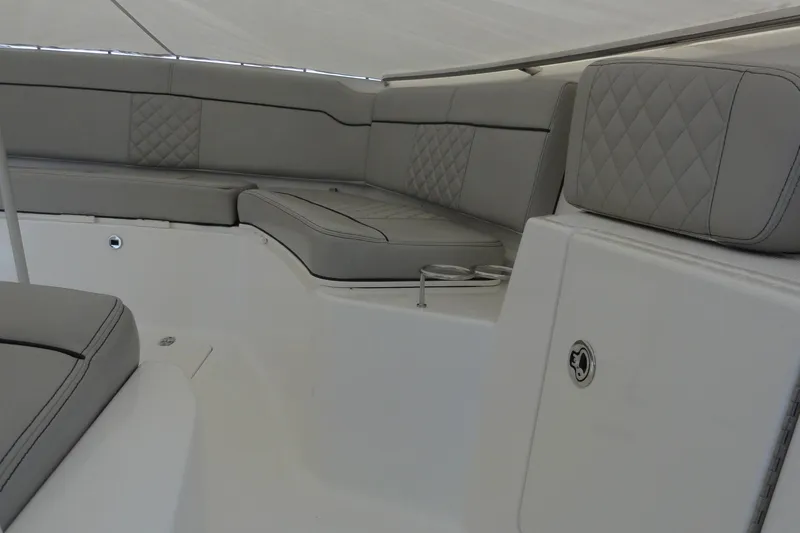  Yacht Photos Pics 2024 Pursuit S 328 Sport boat interior with gray cushioned seating and quilted design.