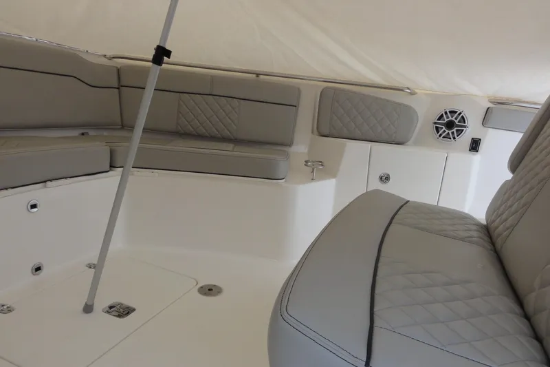 Yacht Photos Pics 2024 Pursuit S 328 Sport boat interior with cushioned seating and speaker system.