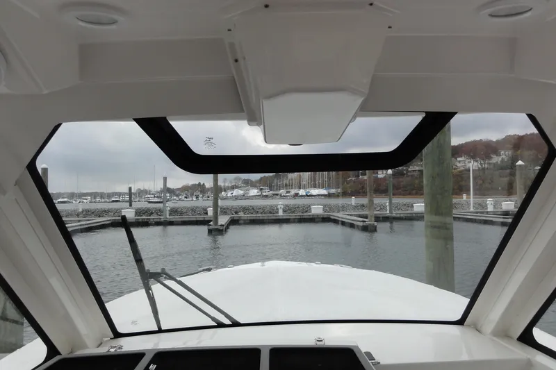  Yacht Photos Pics 2024 Pursuit S 328 Sport boat interior view at marina dock.